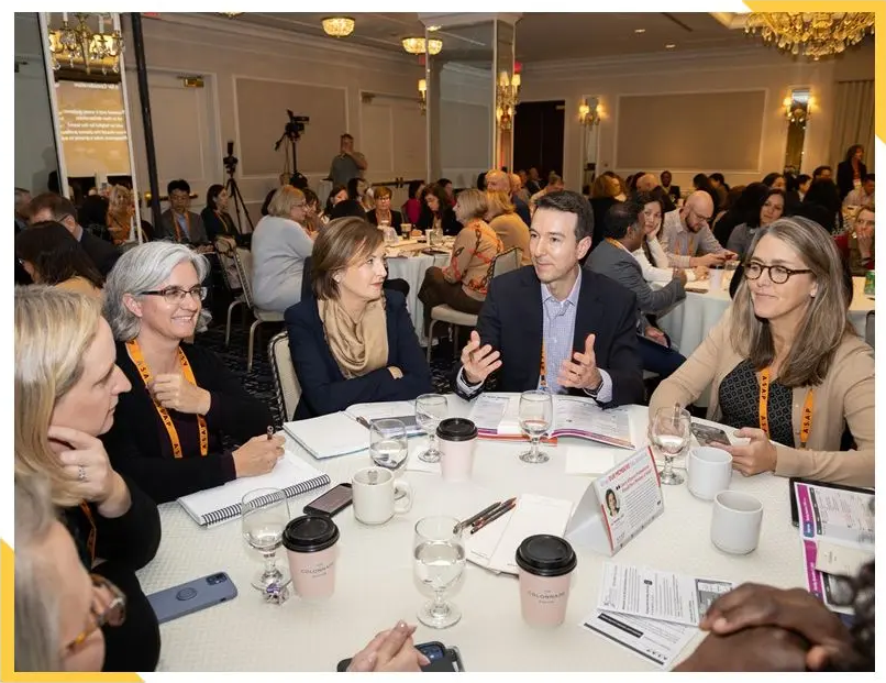 Conference attendees in roundtable discussion